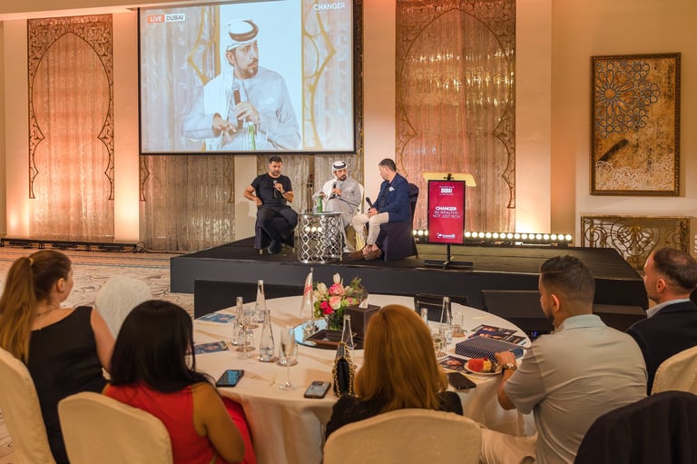 Dr. Sultan Alshaali leading panel discussion at formal event with seated audience members